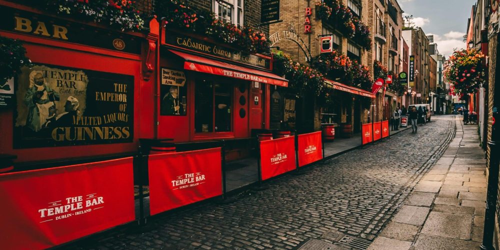 A picturesque cobblestone street with vibrant pubs in Temple Bar, Dublin.